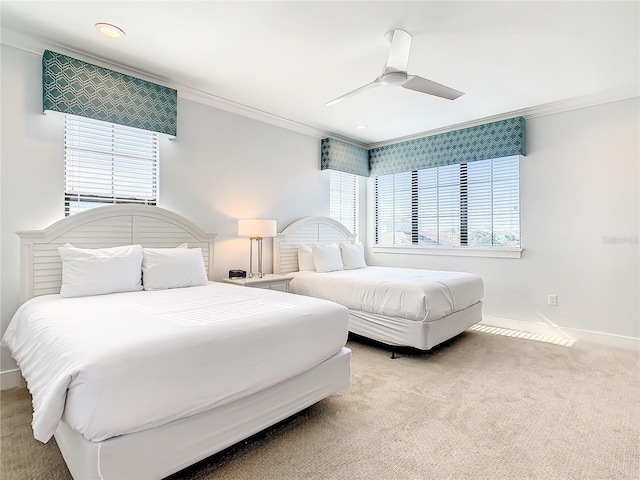 bedroom featuring multiple windows, light carpet, ceiling fan, and crown molding