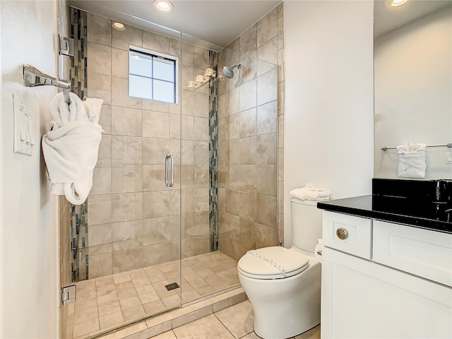 bathroom featuring tile patterned flooring, vanity, toilet, and a shower with door