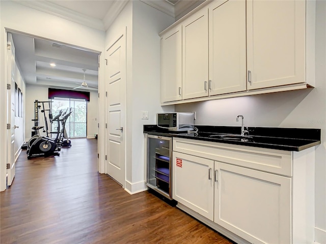 kitchen with white cabinetry, sink, wine cooler, dark hardwood / wood-style floors, and crown molding