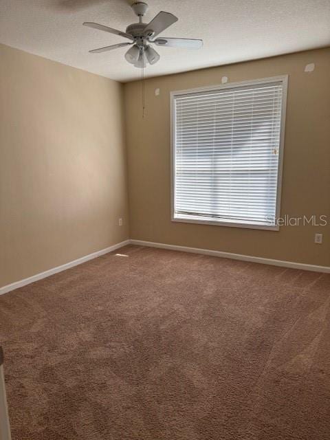 empty room featuring carpet and ceiling fan