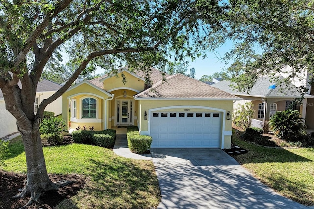 view of front facade with a garage and a front lawn