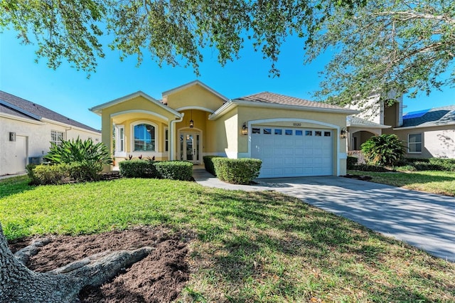 view of front facade featuring french doors, a front yard, and a garage