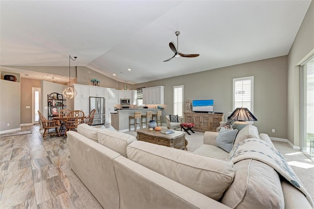 living room featuring vaulted ceiling and ceiling fan