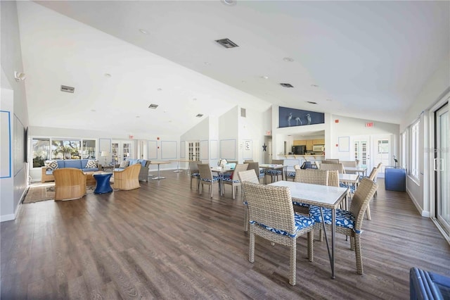 dining area featuring dark hardwood / wood-style floors and high vaulted ceiling