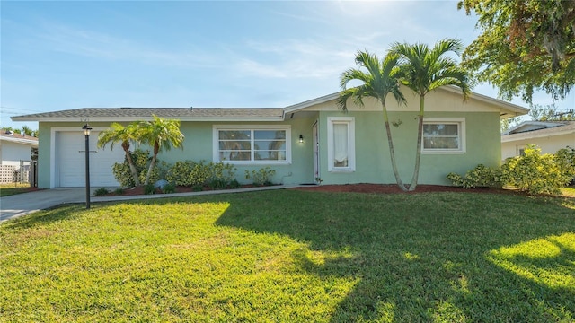 single story home with an attached garage, driveway, a front lawn, and stucco siding