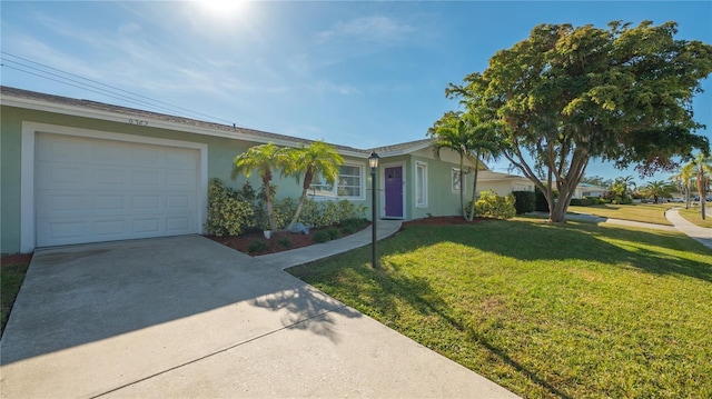 ranch-style home with a garage and a front lawn