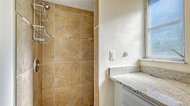 bathroom with tiled shower