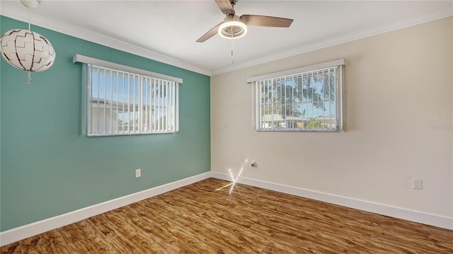 empty room featuring crown molding, ceiling fan, and wood-type flooring