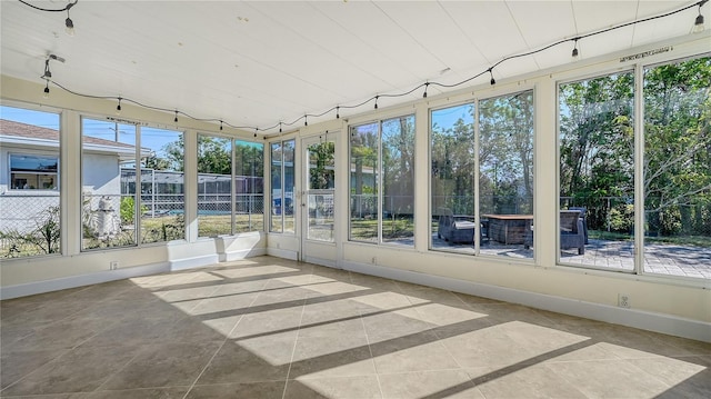 unfurnished sunroom featuring plenty of natural light