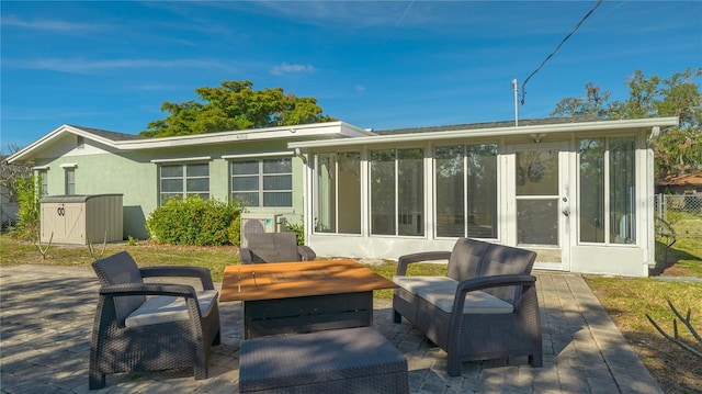 back of property with a patio area and a sunroom