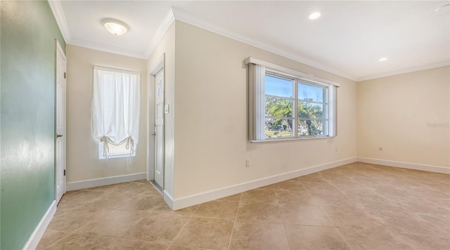 foyer featuring plenty of natural light, ornamental molding, and baseboards