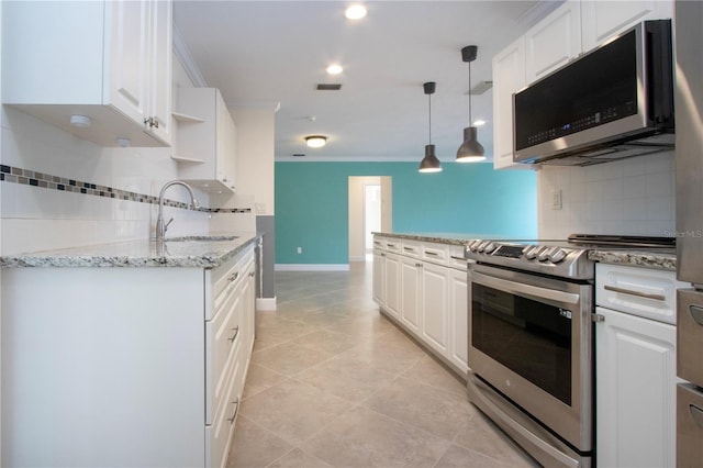 kitchen featuring white cabinetry, appliances with stainless steel finishes, and a sink