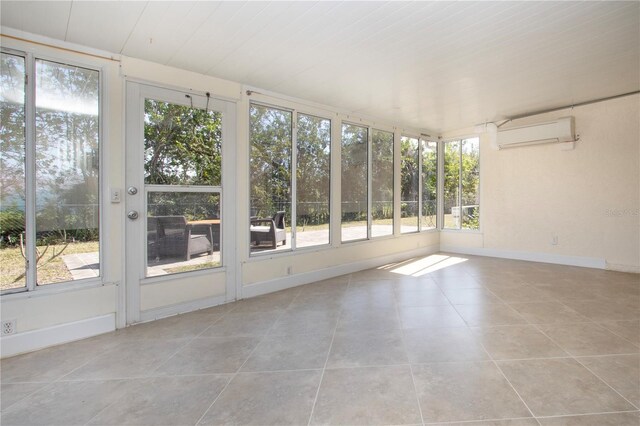 unfurnished sunroom featuring a wall mounted AC