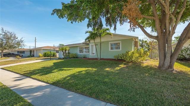 view of front of house featuring a garage, fence, driveway, stucco siding, and a front yard