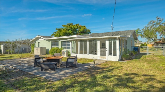 back of property featuring fence, a sunroom, a lawn, a gate, and a patio area