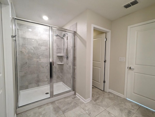 bathroom featuring tile patterned floors and an enclosed shower