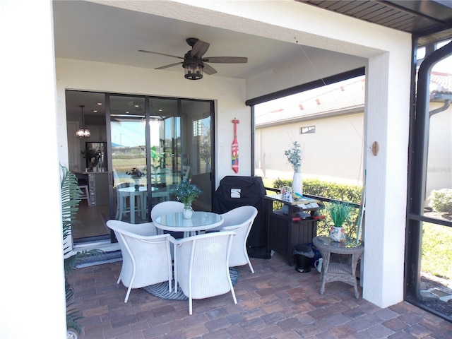 sunroom / solarium featuring ceiling fan