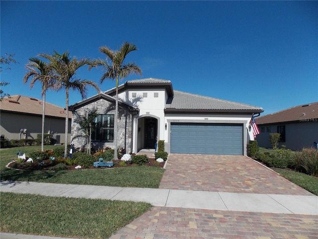 view of front facade with a garage and a front yard