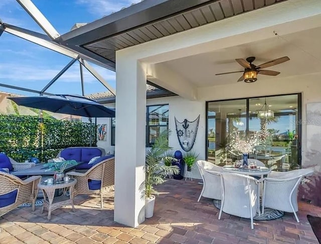 view of patio / terrace with ceiling fan and a lanai