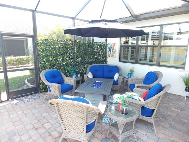 view of patio / terrace with an outdoor living space and glass enclosure