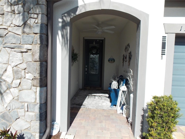 doorway to property featuring ceiling fan