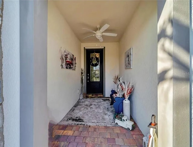 doorway to property featuring ceiling fan