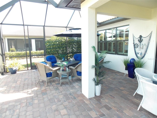 view of patio with glass enclosure