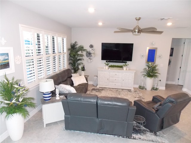 living room featuring light tile patterned floors and ceiling fan