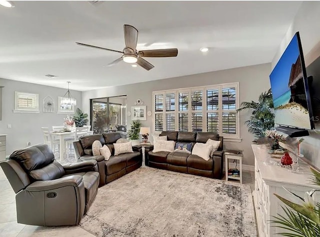 living room featuring plenty of natural light and ceiling fan