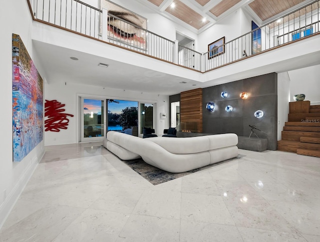 living room featuring a high ceiling, ceiling fan, coffered ceiling, and beam ceiling