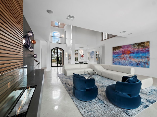 living room with french doors and a high ceiling