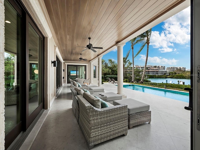 view of patio / terrace with outdoor lounge area, ceiling fan, and a water view