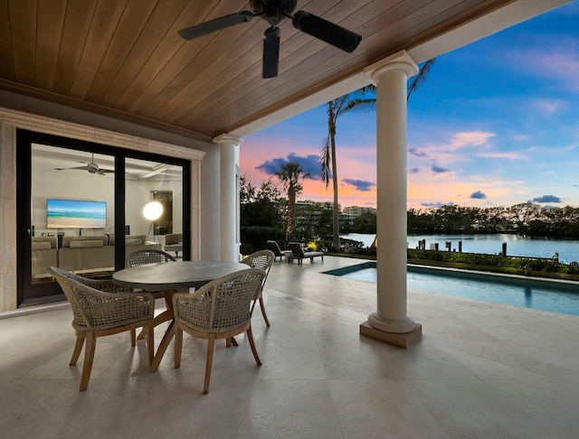 exterior space featuring ceiling fan and a water view