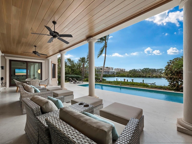 view of swimming pool with an outdoor living space, ceiling fan, a water view, and a patio