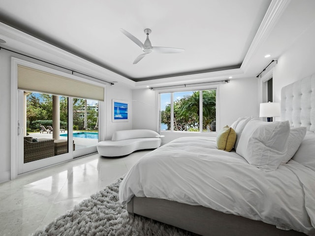 bedroom featuring a tray ceiling, access to exterior, and ceiling fan