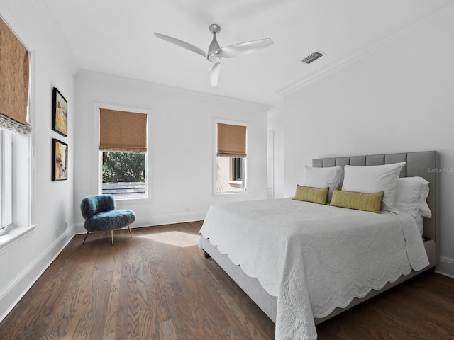 bedroom featuring ceiling fan, dark hardwood / wood-style flooring, ornamental molding, and multiple windows