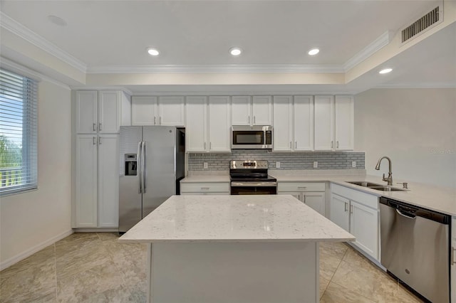 kitchen with crown molding, sink, light stone countertops, and stainless steel appliances