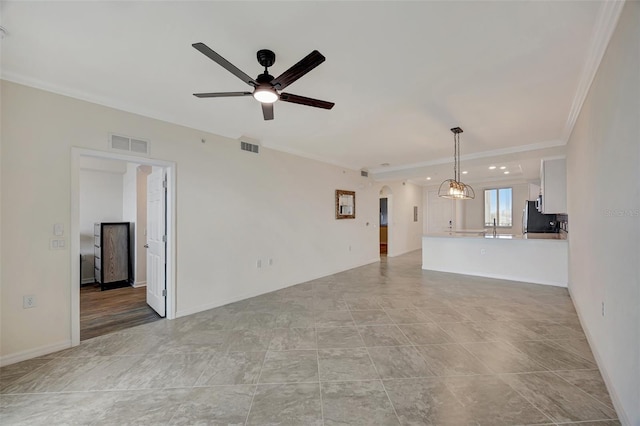 unfurnished living room featuring ceiling fan, crown molding, and sink