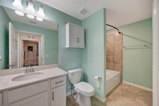 full bathroom with vanity, tiled shower / bath combo, and toilet