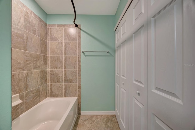 bathroom featuring tile patterned floors and tiled shower / bath