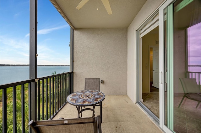 balcony with a water view and ceiling fan