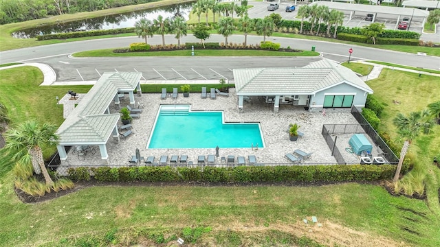 view of pool with a water view and a patio