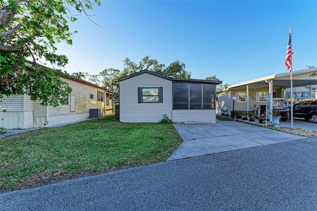 view of front facade with central AC unit and a front lawn