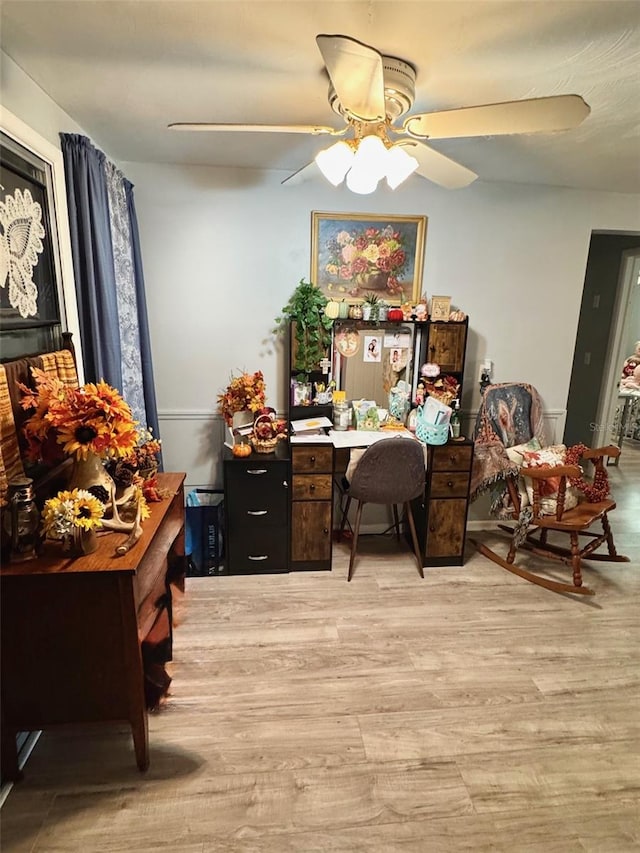 office with ceiling fan and light hardwood / wood-style flooring