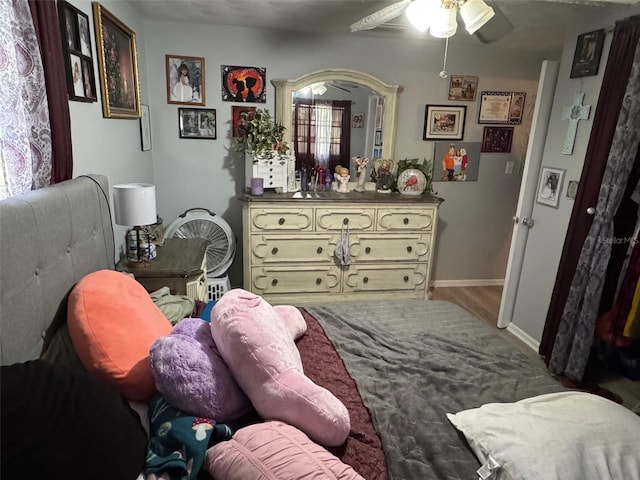 bedroom with hardwood / wood-style floors and ceiling fan