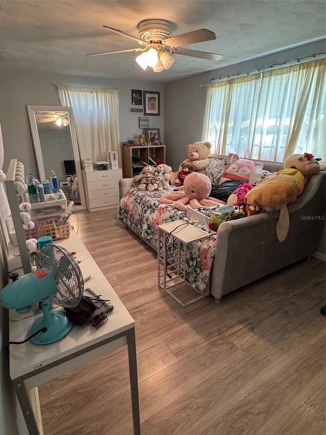 bedroom with ceiling fan and light hardwood / wood-style floors