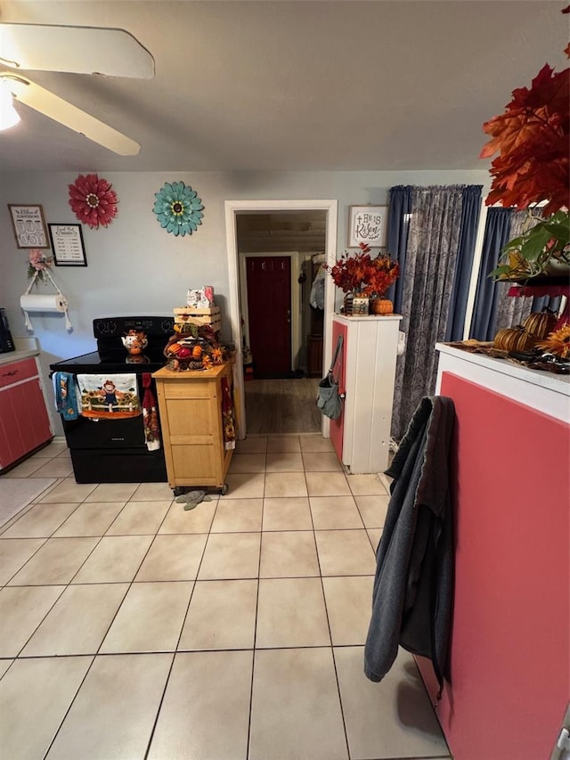 kitchen featuring ceiling fan, light tile patterned floors, and black range with electric cooktop