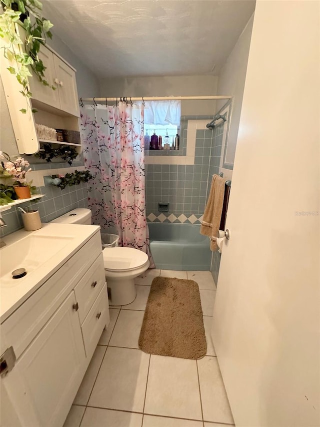 full bathroom with toilet, shower / bath combination with curtain, vanity, and tile patterned floors