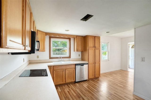 kitchen with black appliances, light hardwood / wood-style floors, and sink