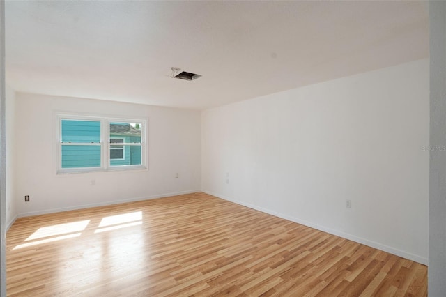 spare room featuring light wood-type flooring